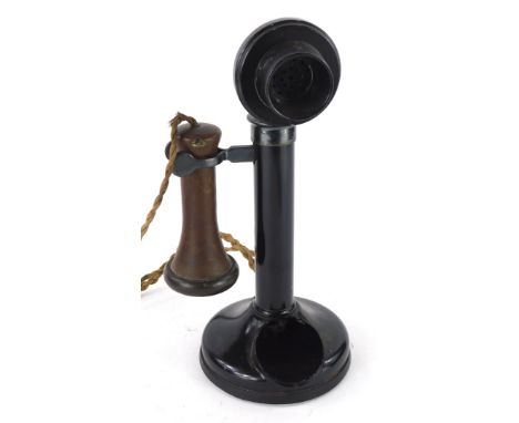 A black metal candlestick cased telephone, with brown Bakelite earpiece.