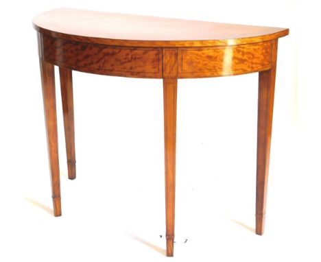 A satinwood and ebony strung demi lune console table, with a crossbanded top on square tapering legs, with collars, 82cm high