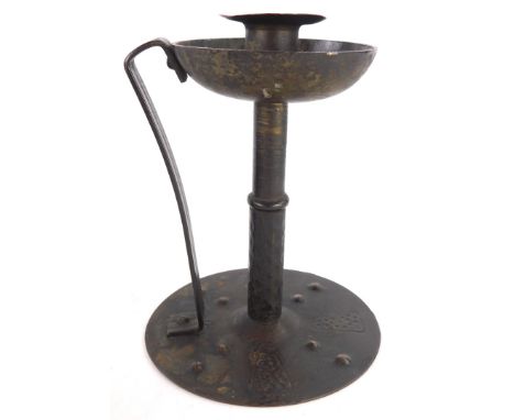 A late 19thC German Jugendstil bronzed chamber candlestick, with hammered decoration, the base indistinctly signed, possibly 