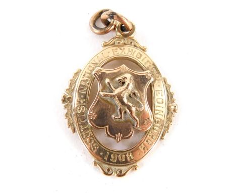 A Scottish National Exhibition 1908 shield pendant, with central shield and applied figure of eight rampant lion, dated 1908 