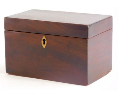 A George III mahogany tea caddy, of plain form, the hinged lid enclosing two lidded compartments, 19cm wide.