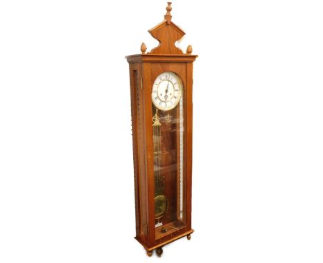 A Vienna wall clock, in a mahogany veneered case with enamel type dial, 128cm high overall.