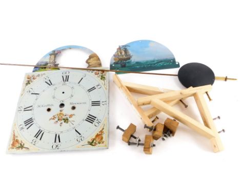 A JC Griffith of Monmouth painted enamel clock face, 43cm high, 31cm wide, together with a group of brackets and a pendulum.