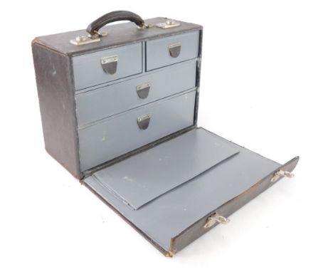 A unusual leather travelling tool or instrument case, the hinged lid enclosing two short and two long drawers with plated mou