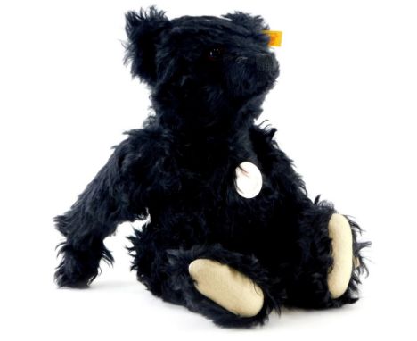 A Steiff Classic black coloured number 32 mohair bear, with original labels, etc., 27cm high seated.