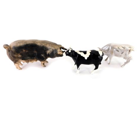 A group of three ceramic figures, to include the Cow Parade Holding Cooperation black and white cow, the Cow Parade lustre fi