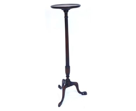A mahogany plant stand or torchere, circular dished top on a turned part fluted column, with tripod base, 107cm high.