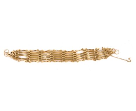 A gate bracelet, of six bar linked design with safety chain, yellow metal, unmarked, 18cm long, 11.6g all in.