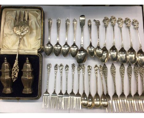 Pair of silver casters in fitted case, various silver teaspoons, South African plated spoons and forks, six other plated cake