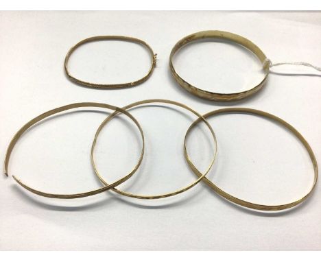 Four 9ct gold bangles and one silver gilt bangleFour 9ct gold bangles weigh 14.7 grams (one bangle is broken) 