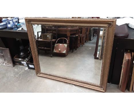 Bevelled wall mirror in ornate gilt frame, 121cm x 98cm