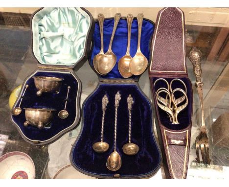 Pair silver salts and spoons in case, four silver teaspoons, three silver Apostle salt spoons in case, silver handled fork an