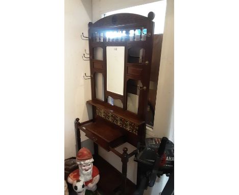 Late Victorian walnut hall stand with bevelled mirror and tiled back and drawer below,  91cm wide, 29cm deep, 204cm high