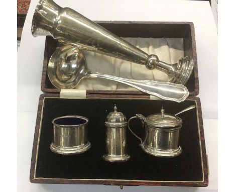 Silver three piece cruet set in fitted case, silver spill vase and German silver (800) ladle