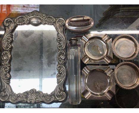 Pair silver ashtrays, pair silver pin dishes, silver topped glass bottle, Ronson table lighter and plated mirror