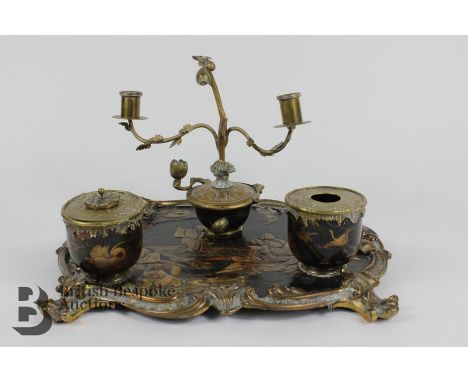 French chinoiserie ink stand, 19th century, having a black lacquered tray depicting a family picnic, mounted with two brass a