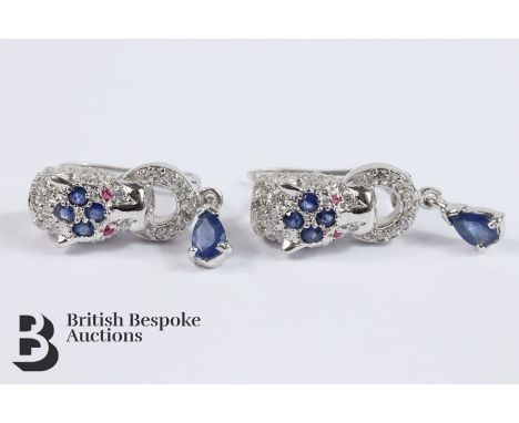 Pair of silver panther earrings, set with sapphire and ruby eyes.&nbsp;