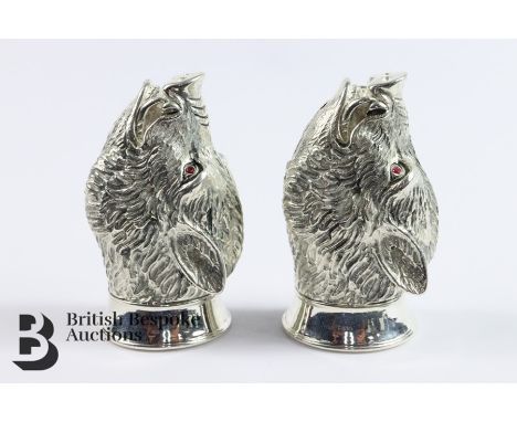 Silver plated condiments, modelled as wild boar heads with ruby eyes, approx 6 cms.&nbsp;