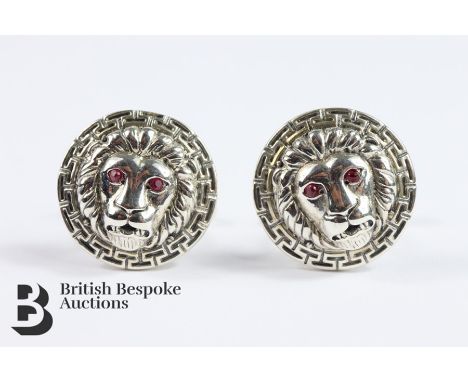 Pair of unisex cufflinks, cast as lion masks with ruby eyes, approx 19.5 gms.