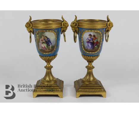 Pair of 19th century Sevres porcelain and ormulu vases, painted with a young lovers in a garden setting and a farm dwelling t