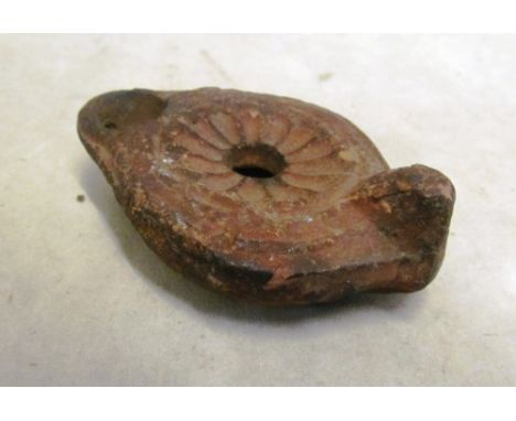 A Roman pottery oil lamp