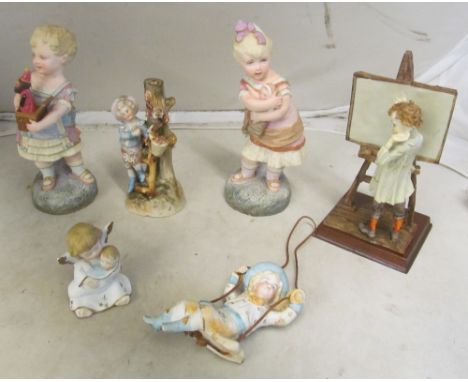 A pair of bisque children and four other figures of children