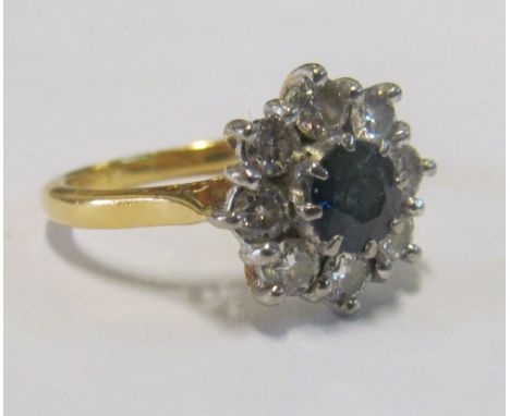 An 18ct gold sapphire and diamond cluster ring size K/L