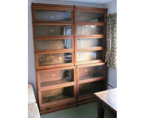 A pair of oak six tier Globe Wernicke bookcases 1 glass missing