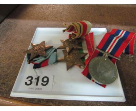 A WW2 Italy star, Africa Star, 1939-45 Star and a Peace medal