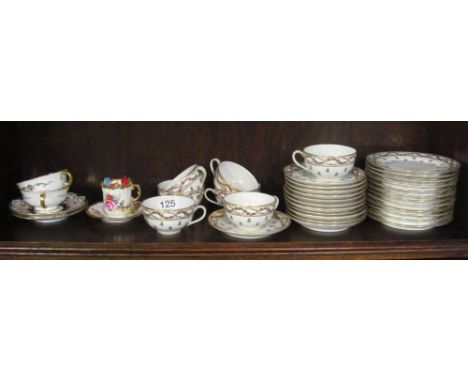 A pretty teaset, 12 saucers, 7 cups (1a/f), 12 plates (1a/f) together with 2 cups and saucers and cup and saucer