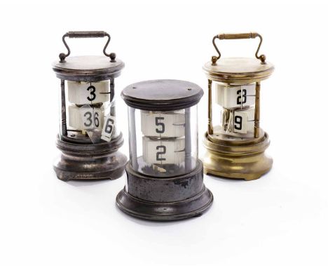 EARLY 20TH CENTURY STEEL CASED TICKET CLOCKof cylindrical form, housing two sets of tickets, housing clockwork movement in ba