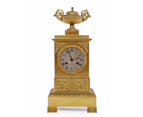 19TH CENTURY FRENCH GILTMETAL MANTEL CLOCK OF EMPIRE DESIGNthe stepped cornice with urn finial, the circular silvered dial be