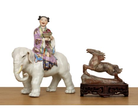 Porcelain model of an elephant and a girlChinese, mid-20th Centurythe seated figure holding a basket of flowers, 22cm wide x 