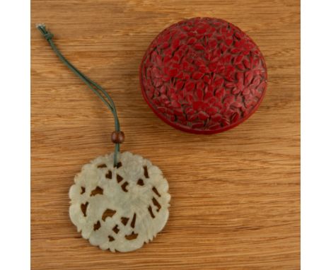 Cinnabar lacquer carved circular box and a jade pendantChinesethe pendant carved with a bird, 5cm diameter and the box 6.5cm 