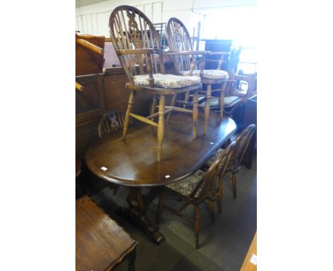 An Ercol dark oak refectory table and four chairs 