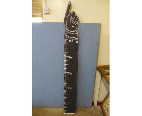 A painted wooden measuring stick/sign 