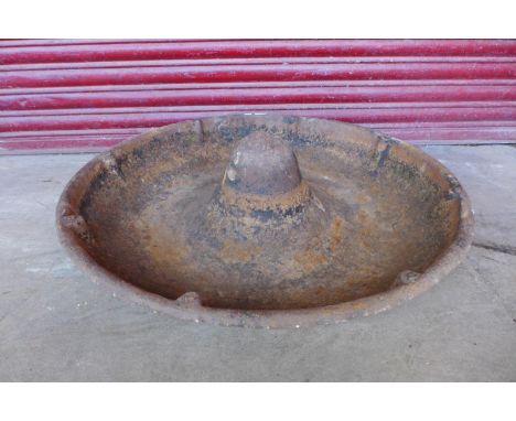 A cast iron Mexican hat feeding trough 
