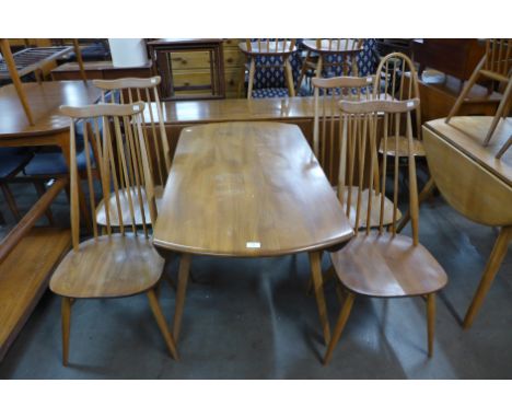 An Ercol Blonde elm and beech Windsor drop leaf table and four Goldsmith chairs 