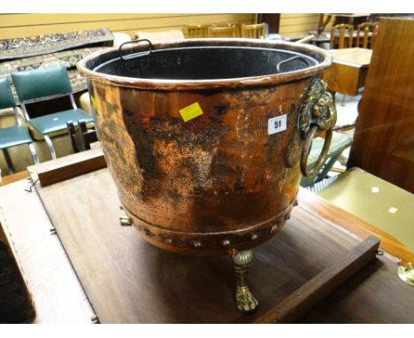 An antique copper log bin with three brass claw feet & brass lion head ring handles together with liner