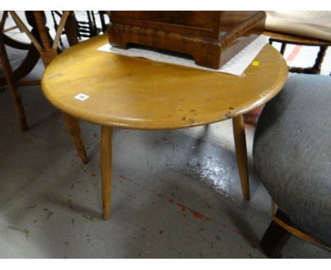 A lightwood Ercol circular coffee table