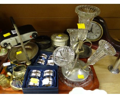 A parcel of mainly metalware including epergne, cased napkin rings together with a reproduction mantel clock etc