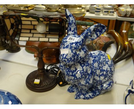 A Tiffany-style adjustable reading lamp and a pottery blue & white rabbit