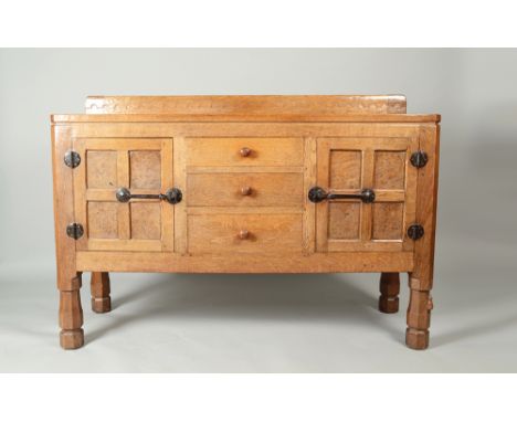 A Robert Mouseman Thompson of Kilburn oak sideboard, with three central drawers flanked by a pair of quarter panelled cupboar