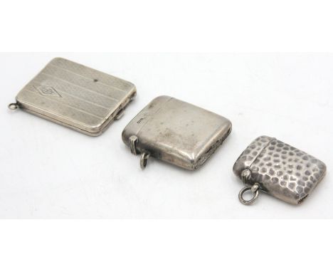 A plain silver vesta case and one other vesta case, together with an engine turned silver matchbook holder, 3oz.