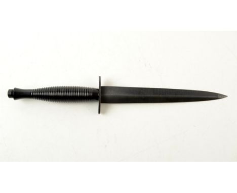 A modern Fairbairn-Sykes knife, by William Rodgers, Sheffield, England, in leather scabbard, length 30cm.