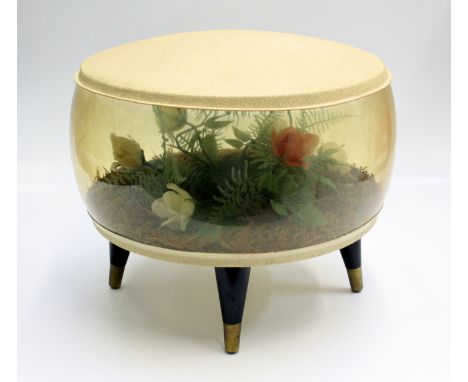 A 1960's Puffin inflatable pouffe, the body with floral interior scene, on ebonised tapering legs and brass feet, makers stam