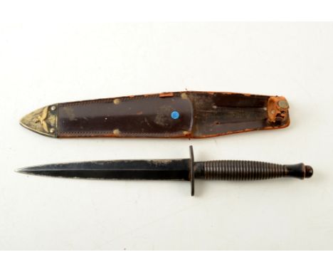 A Fairbairn-Sykes knife, by William Rodgers, Sheffield, England, in leather scabbard, length 30cm. Condition report: Hilt sta