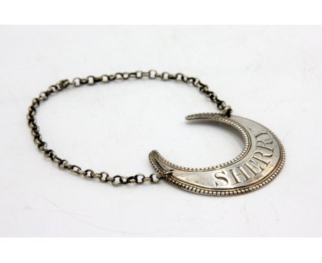 A George III silver decanter label for Sherry in the form of a crescent moon with beaded border, by Susannah Barker circa 178