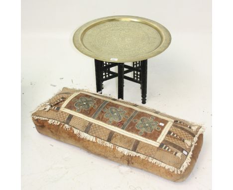An Egyptian brass circular tray, 20th century, on carved folding stand, tray diameter 59cm, together with an African leather 