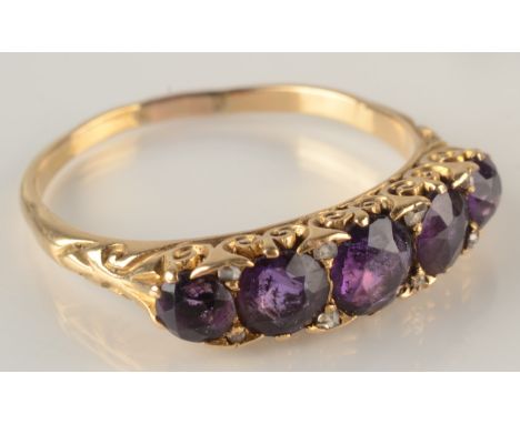 A Victorian style 18ct gold amethyst set ring, the stones separated by tiny diamonds.